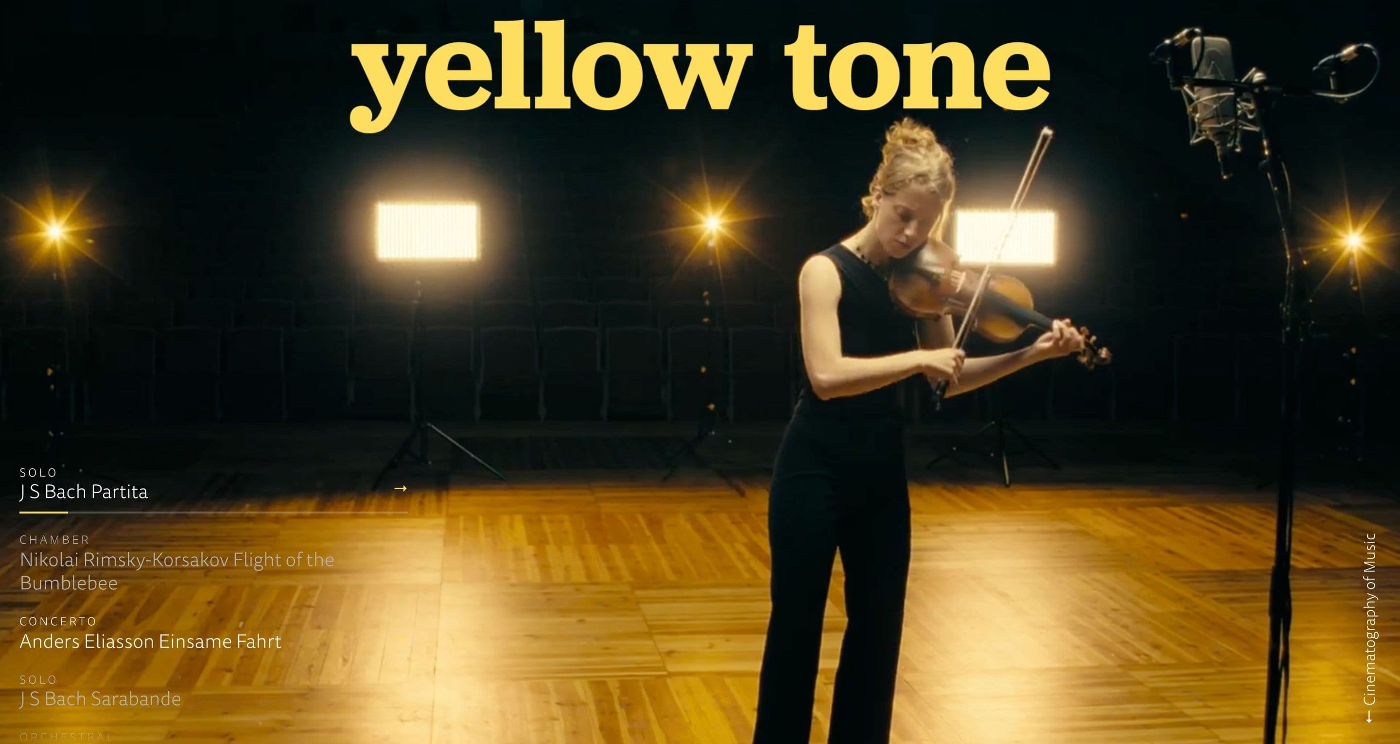 The home page on yellowtone.se, with a violinist in black on a wooden stage between warm studio lights